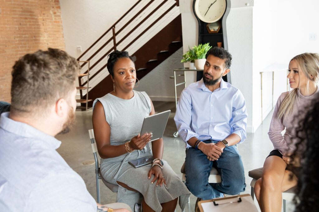 therapist and patients sitting in circle during therapy