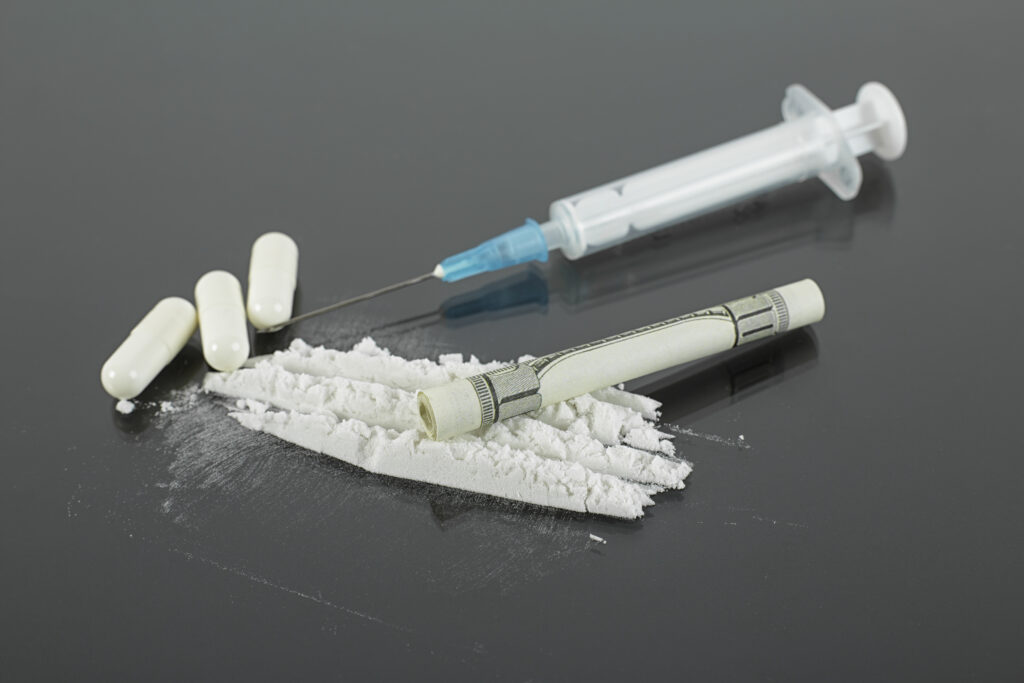 drugs pills needle dollar bill