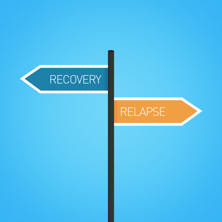 Recovery vs relapse choice road sign concept